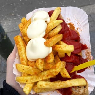 A currywurst with fries