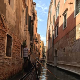 A gondola in a narrow canal in Venice